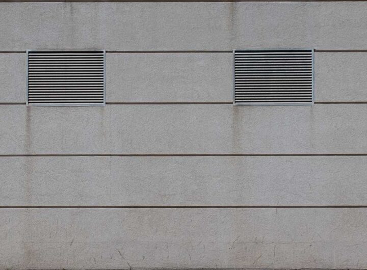 Deux grilles d'aération sur un mur en béton